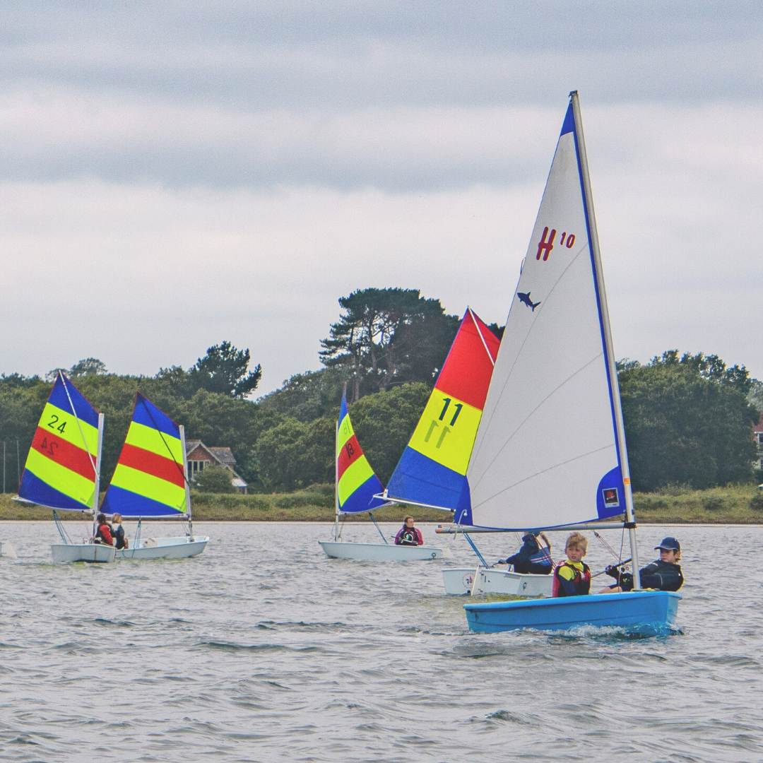 Young sailors learning to sail in dinghies