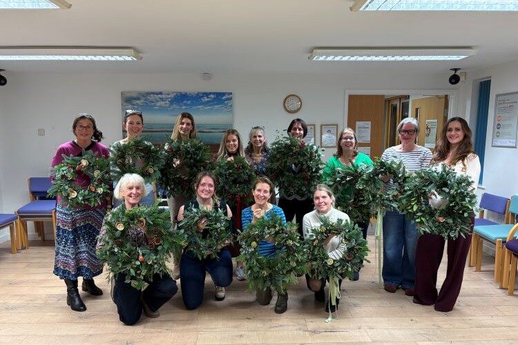 Ladies with their wreaths made in a wreathmaking workshop